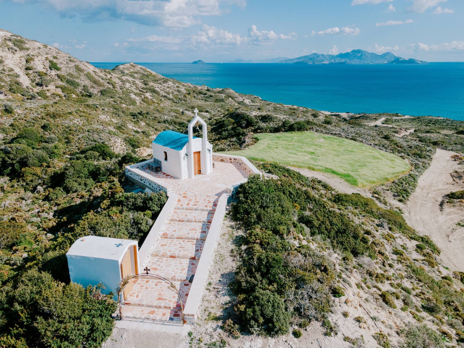 Small white chapel on the hill near the villas overlooking the sea